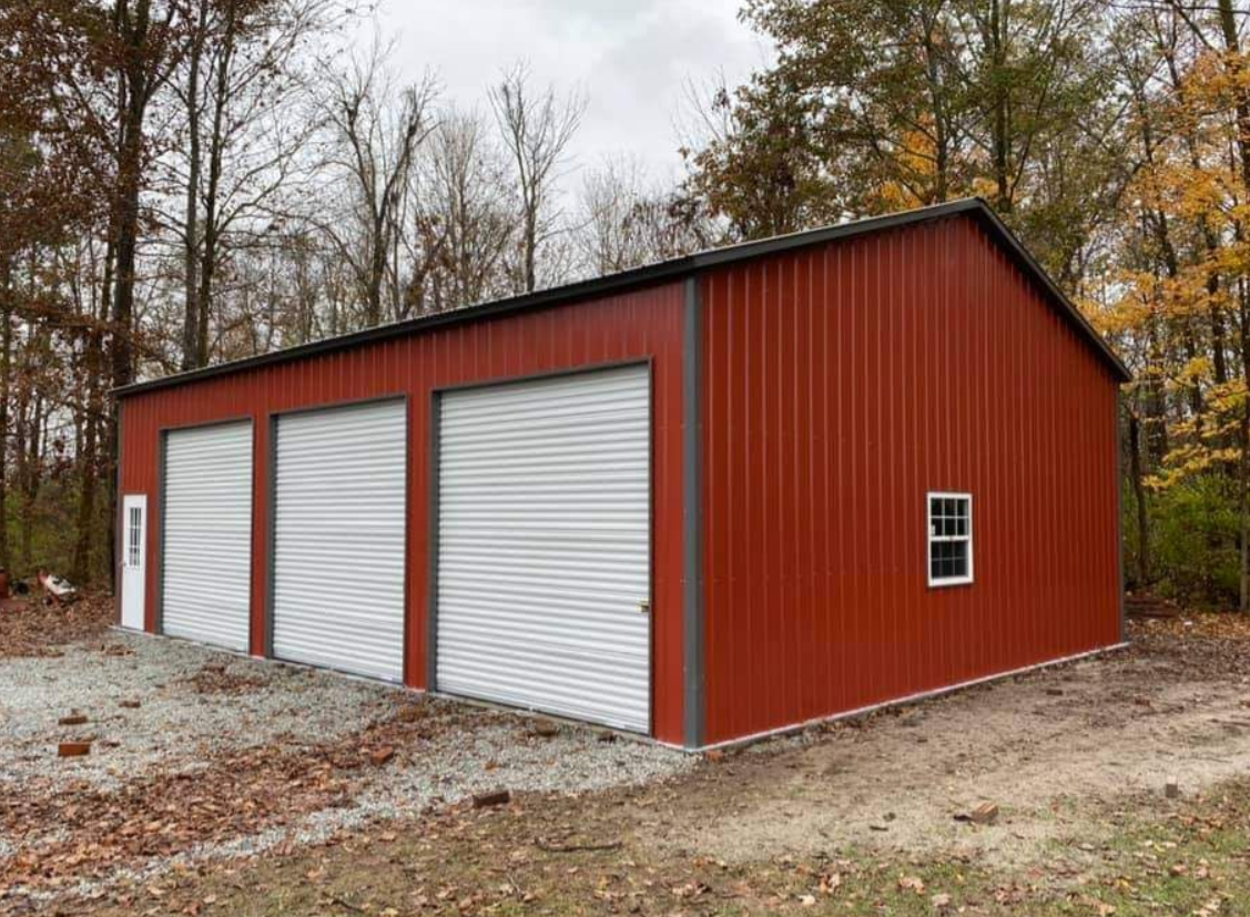 Barn red metal garage with three roll-up doors and a walk-in door